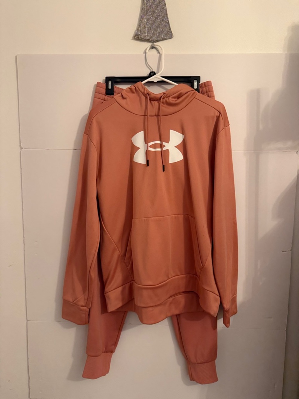 Under Armour  orange Pullover Hoodie with straight leg loose fit jogger pants.